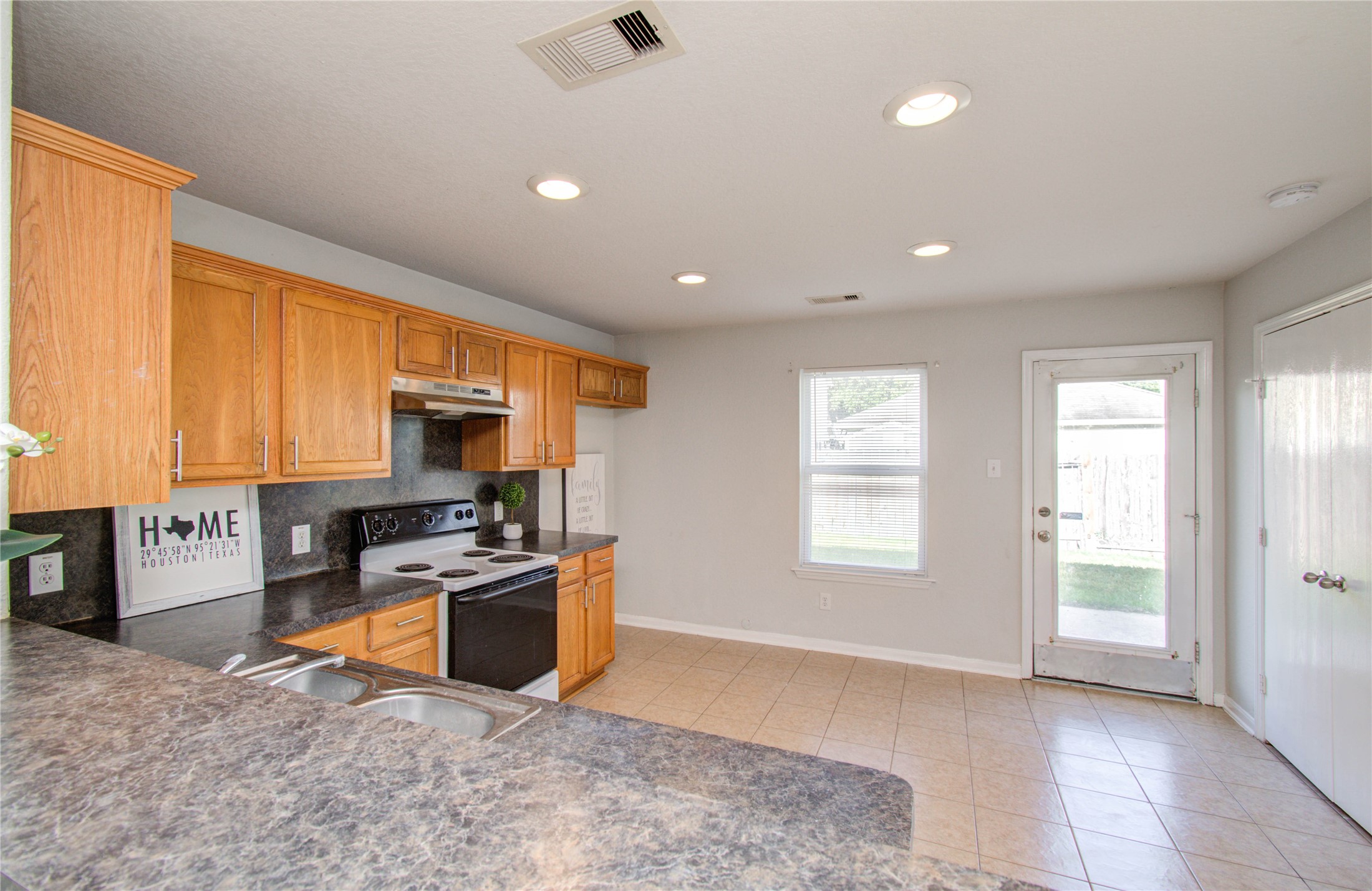 13231 Ridgewood Knoll Lane Houston, TX 77047 - Photo 12 of 23 a kitchen with stainless steel appliances granite countertop a stove a sink and a refrigerator