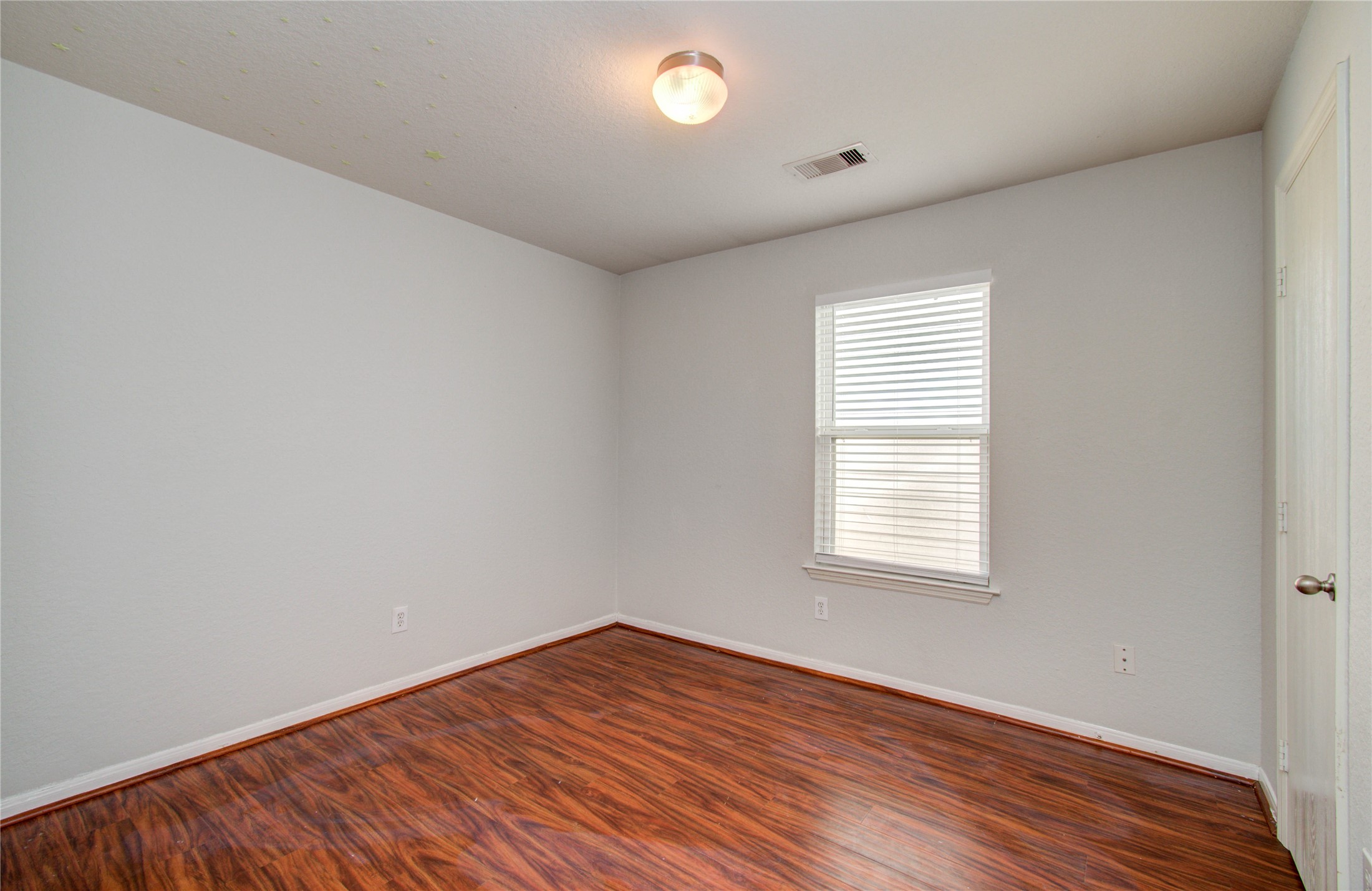 13231 Ridgewood Knoll Lane Houston, TX 77047 - Photo 19 of 23 an empty room with wooden floor and windows