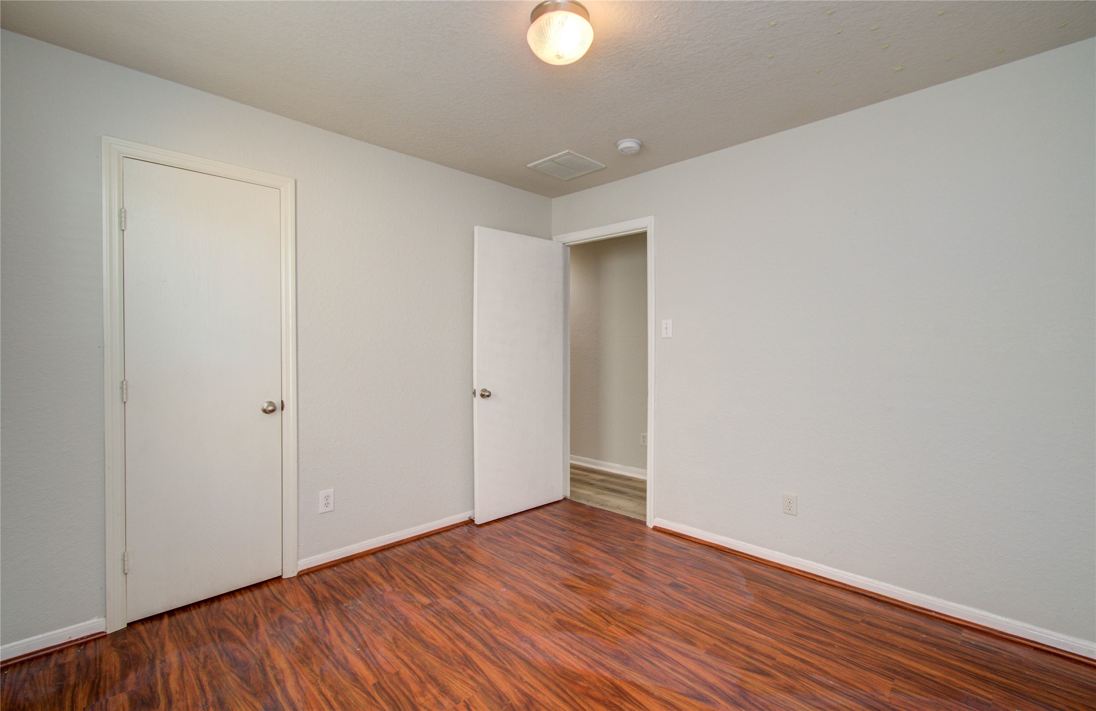 13231 Ridgewood Knoll Lane Houston, TX 77047 - Photo 20 of 23 a view of an empty room with wooden floor