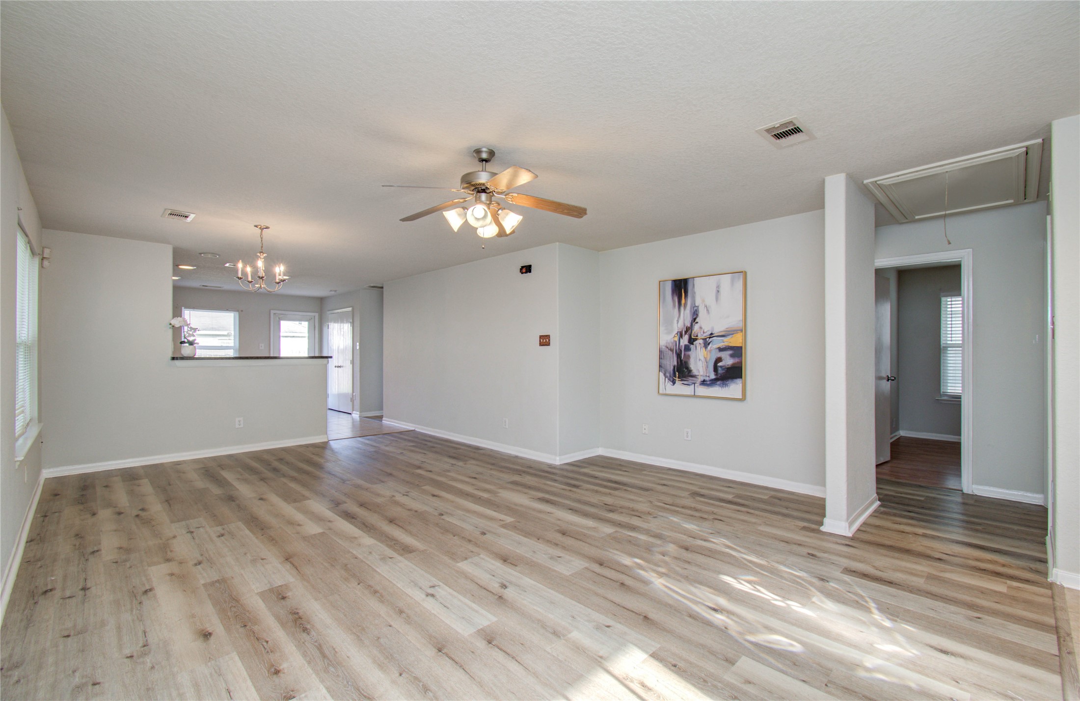 13231 Ridgewood Knoll Lane Houston, TX 77047 - Photo 3 of 23 wooden floor in an empty room with a window