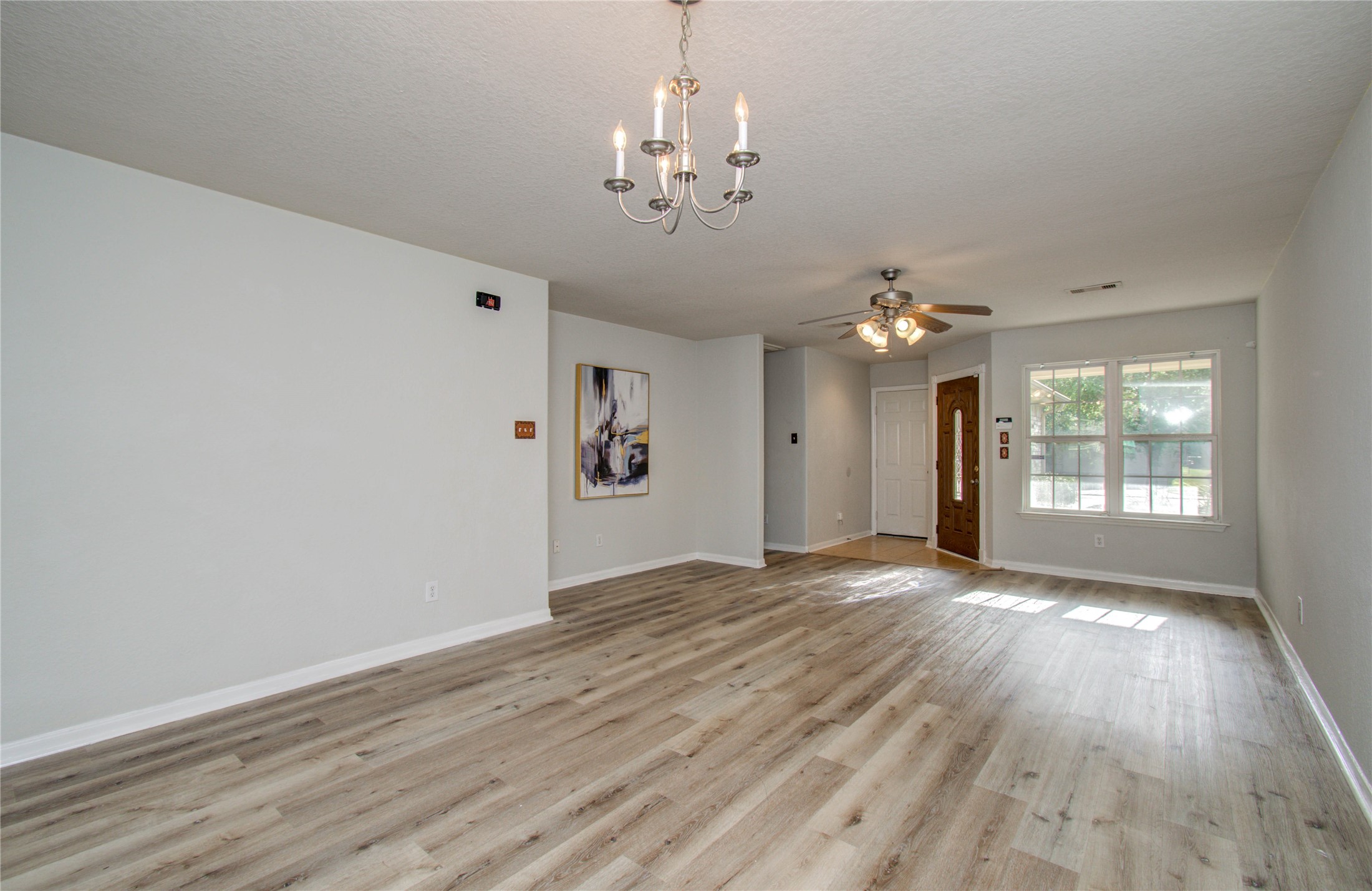 13231 Ridgewood Knoll Lane Houston, TX 77047 - Photo 4 of 23 wooden floor in an empty room with a window