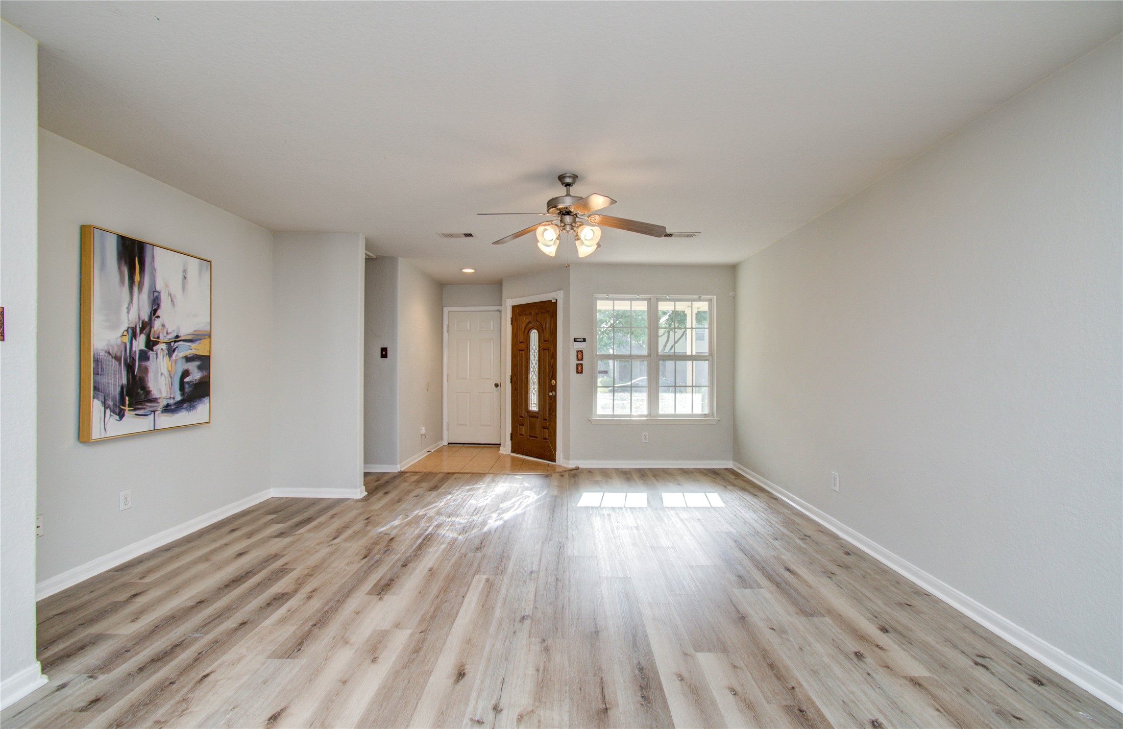 13231 Ridgewood Knoll Lane Houston, TX 77047 - Photo 5 of 23 wooden floor in an empty room with a window