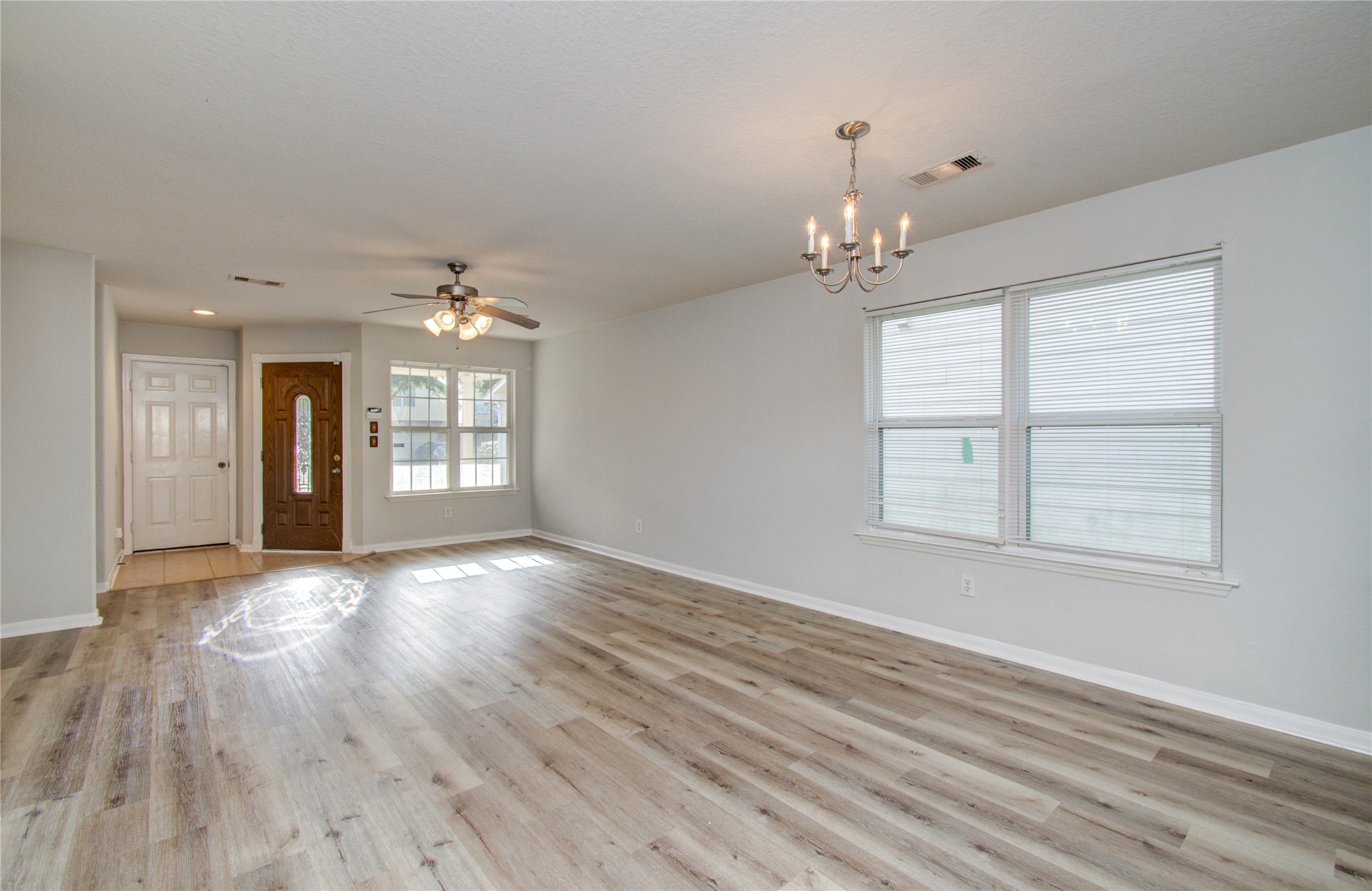 13231 Ridgewood Knoll Lane Houston, TX 77047 - Photo 6 of 23 wooden floor in an empty room with a window