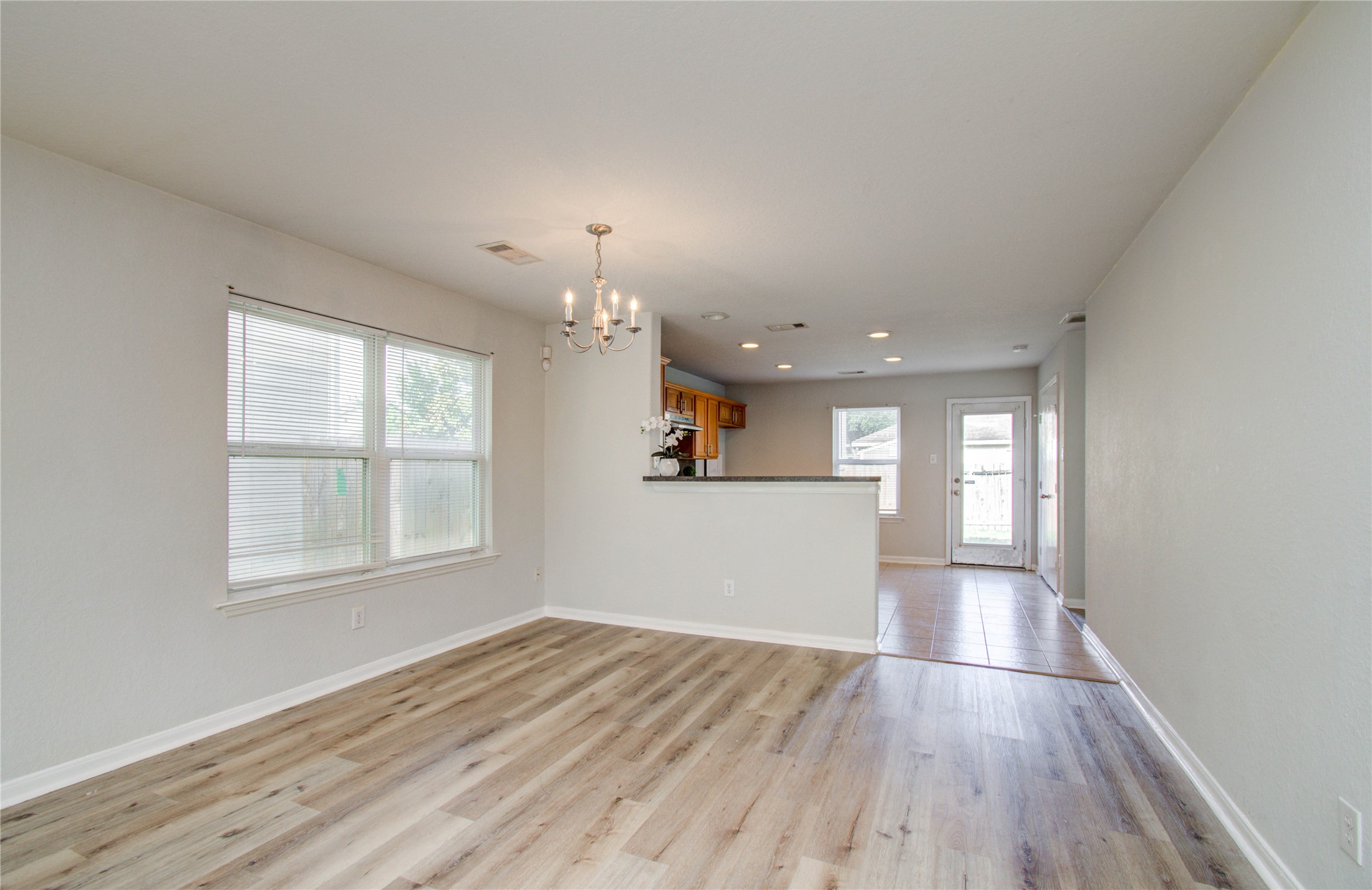 13231 Ridgewood Knoll Lane Houston, TX 77047 - Photo 7 of 23 an empty room with wooden floor and windows