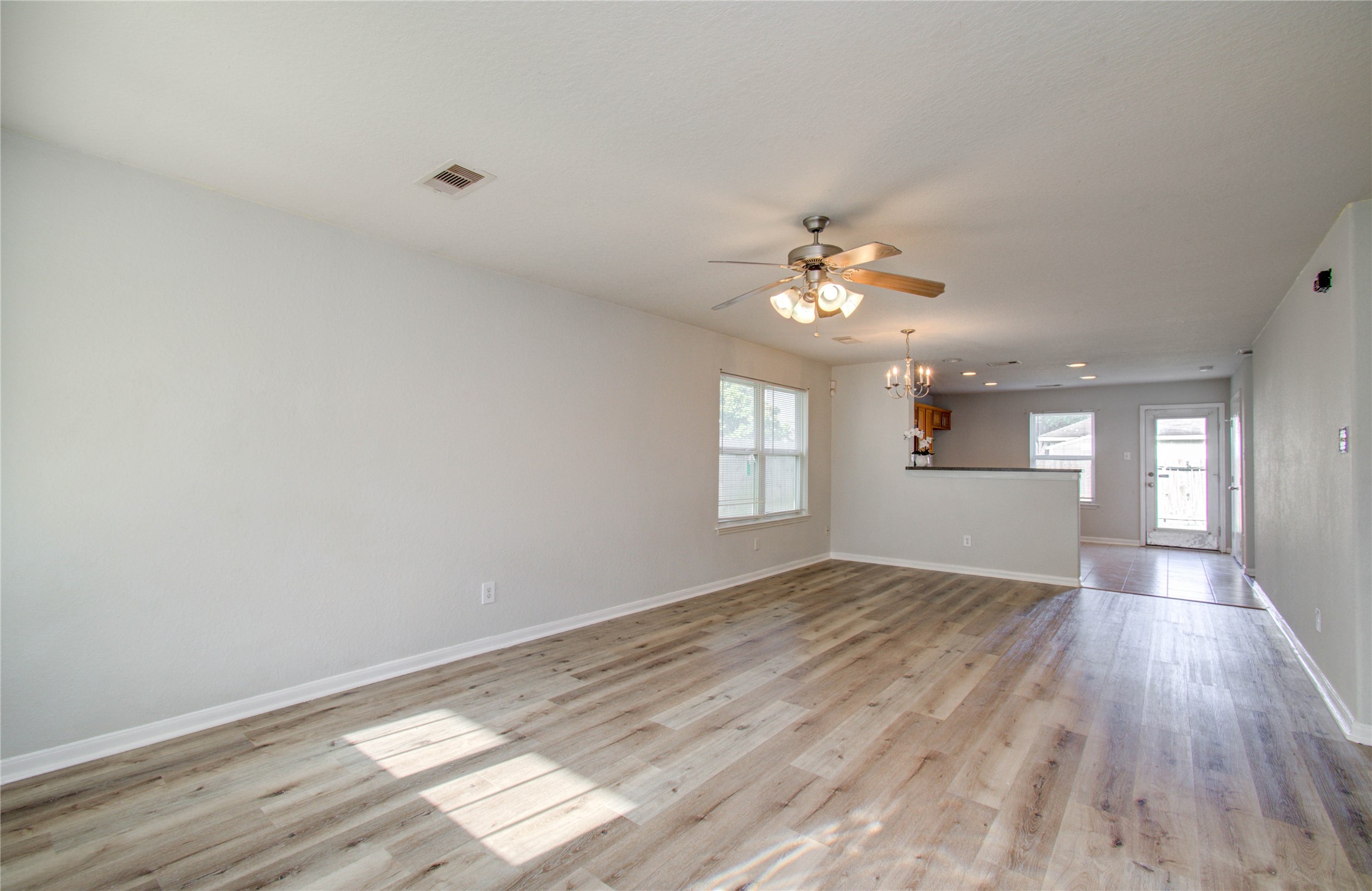 13231 Ridgewood Knoll Lane Houston, TX 77047 - Photo 8 of 23 wooden floor in an empty room with a window