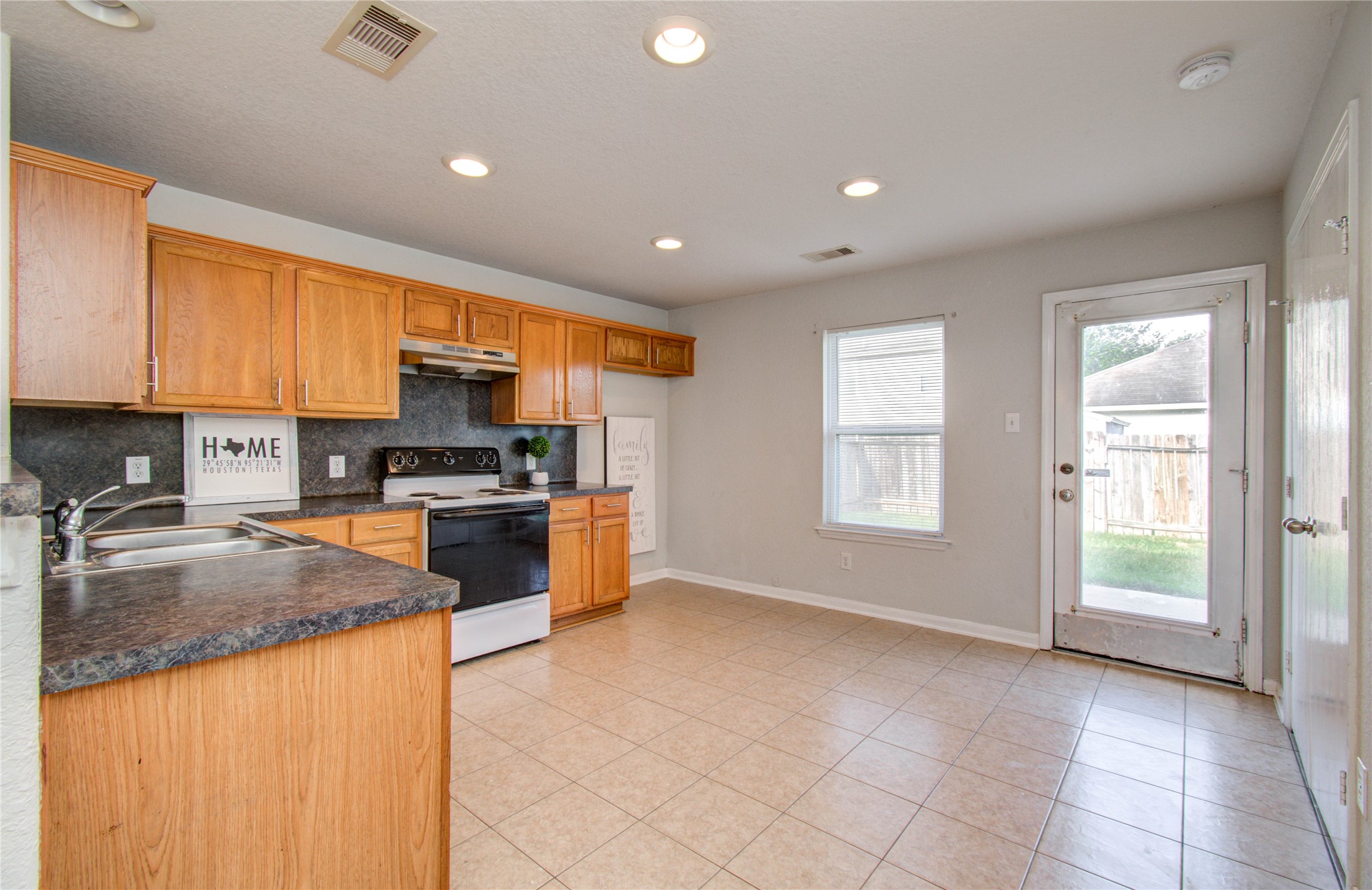 13231 Ridgewood Knoll Lane Houston, TX 77047 - Photo 9 of 23 a kitchen with stainless steel appliances granite countertop a stove a sink and a refrigerator