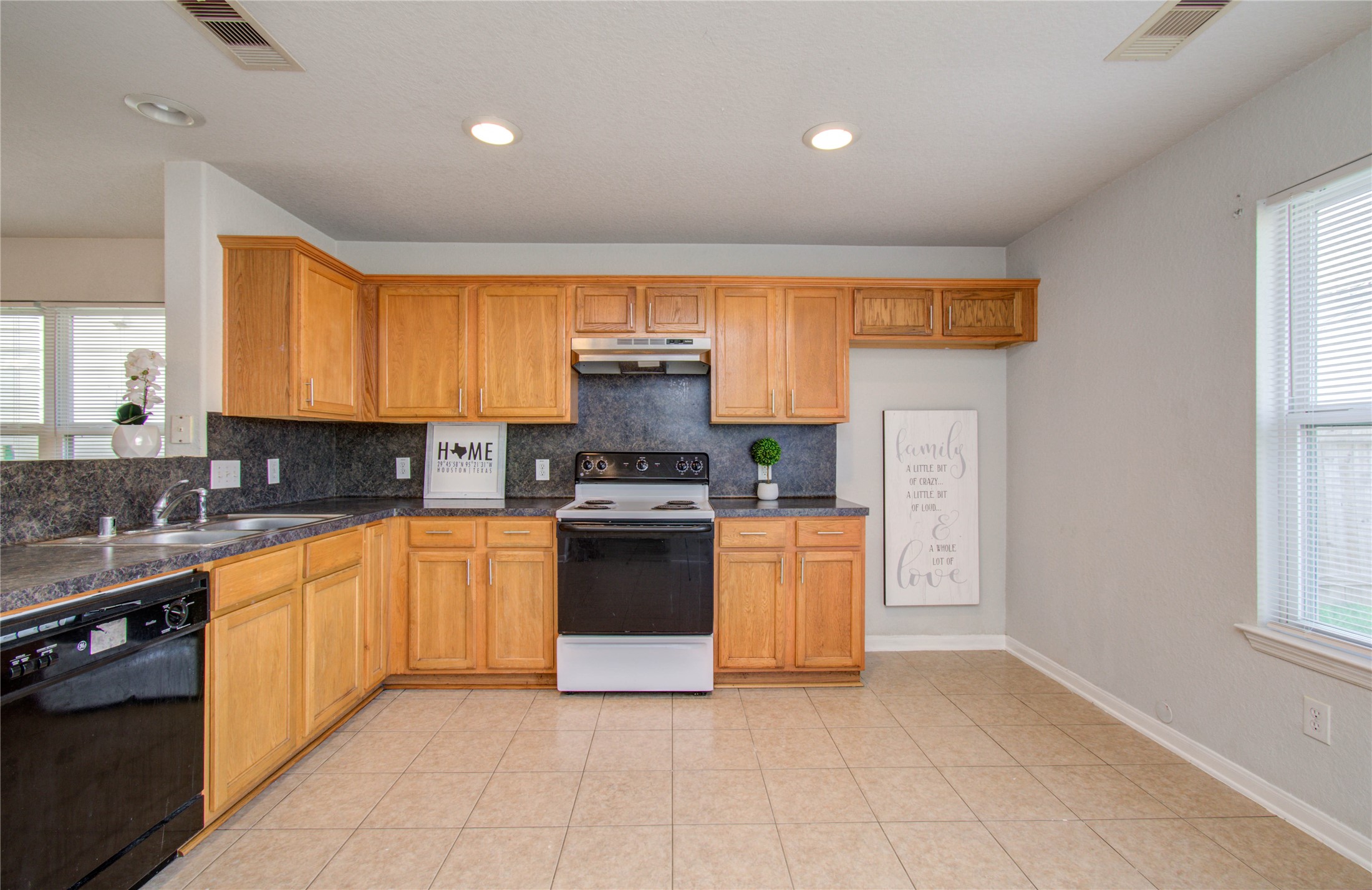13231 Ridgewood Knoll Lane Houston, TX 77047 - Photo 10 of 23 a kitchen with stainless steel appliances granite countertop a stove a sink and a refrigerator