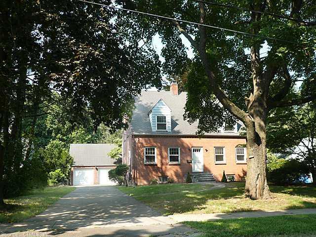 a front view of a house with a yard garage and outdoor seating