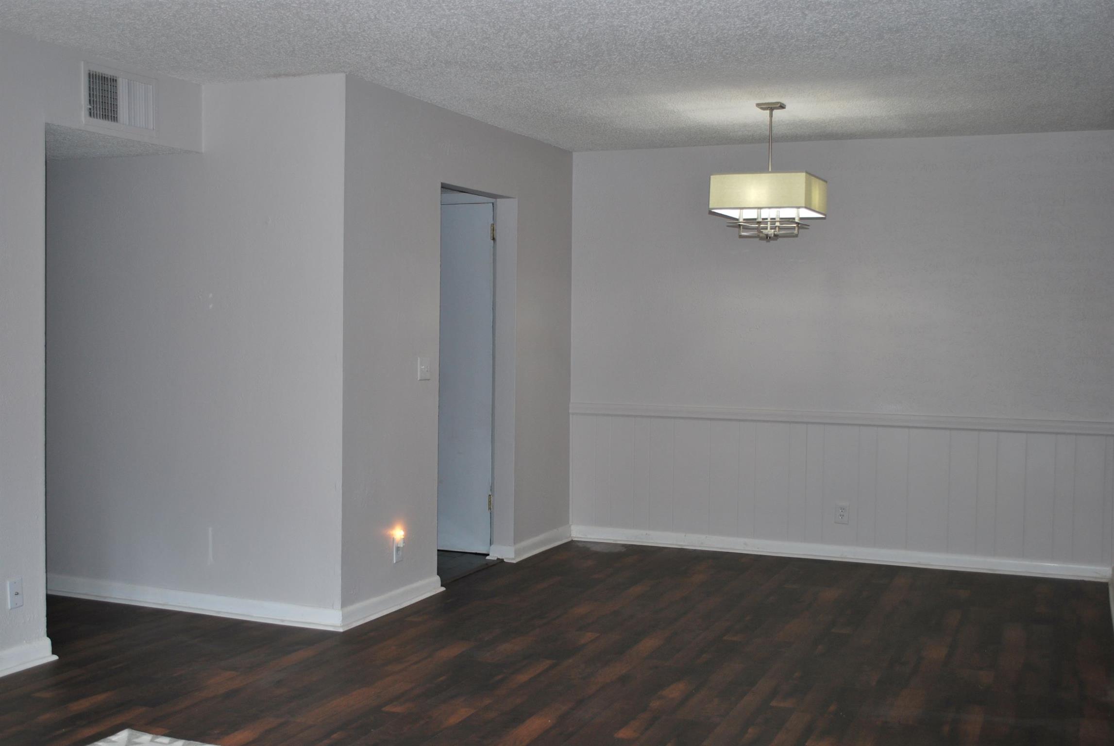 21 Vaughns Gap Road Nashville, TN 37205 - Photo 2 of 12 an empty room with wooden floor and window