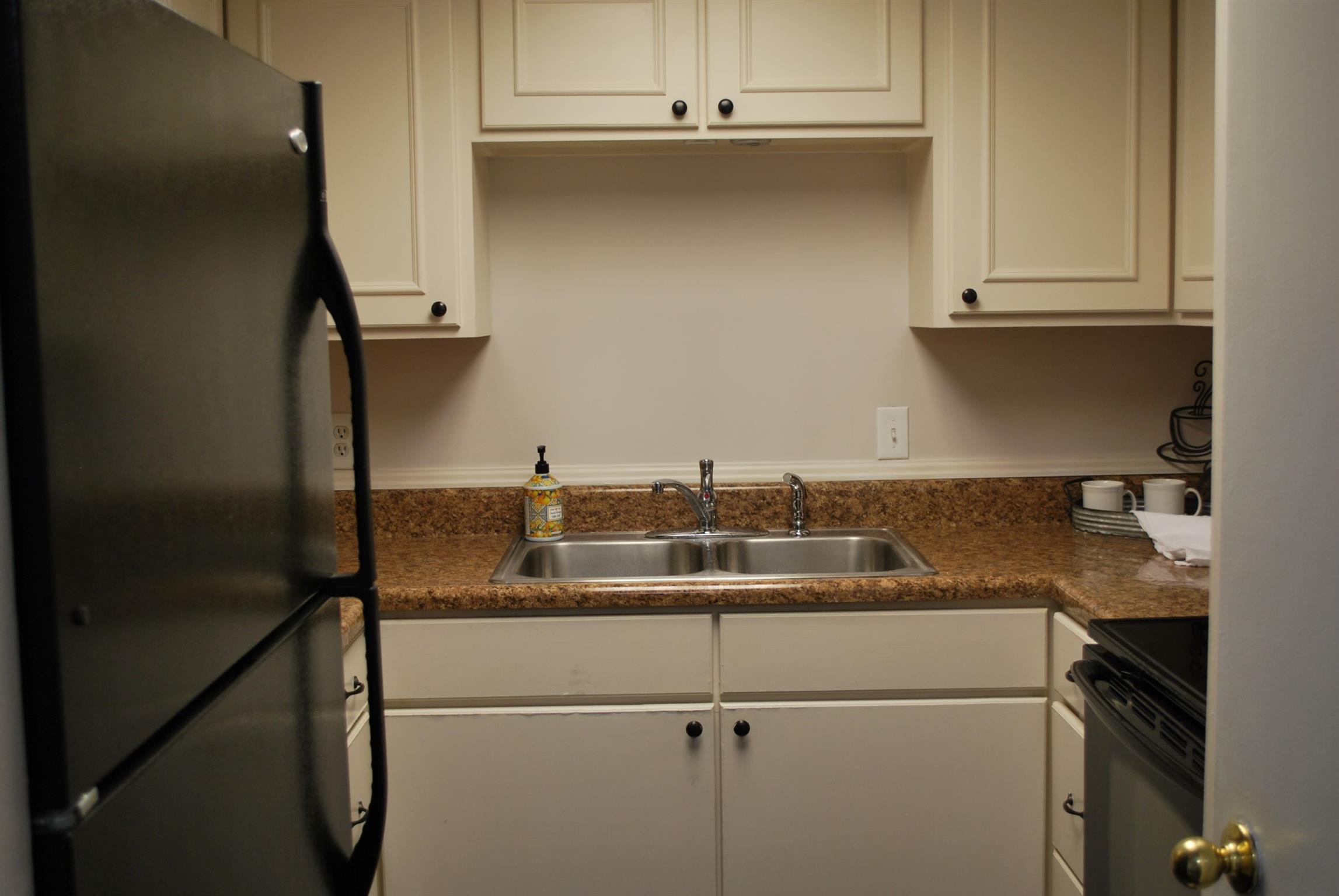 21 Vaughns Gap Road Nashville, TN 37205 - Photo 3 of 12 a kitchen with a sink and cabinets