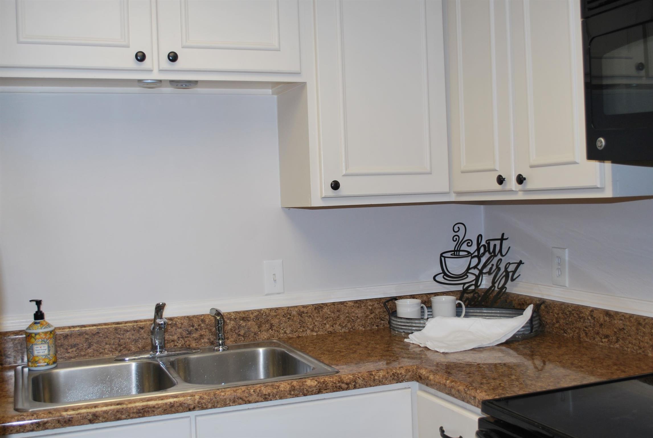 21 Vaughns Gap Road Nashville, TN 37205 - Photo 5 of 12 a kitchen with granite countertop a sink and white cabinets