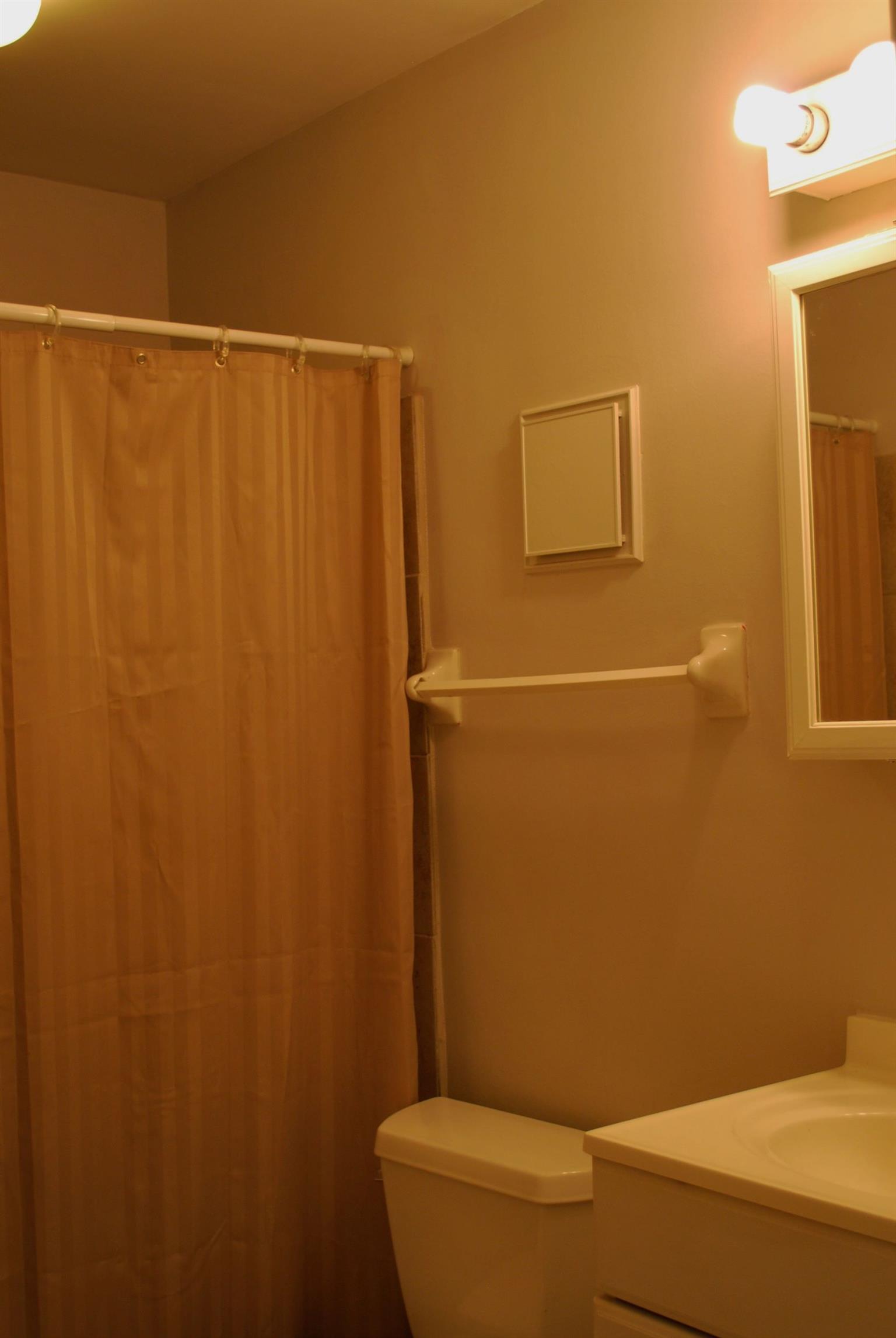 21 Vaughns Gap Road Nashville, TN 37205 - Photo 7 of 12 a bathroom with a toilet and a shower curtain