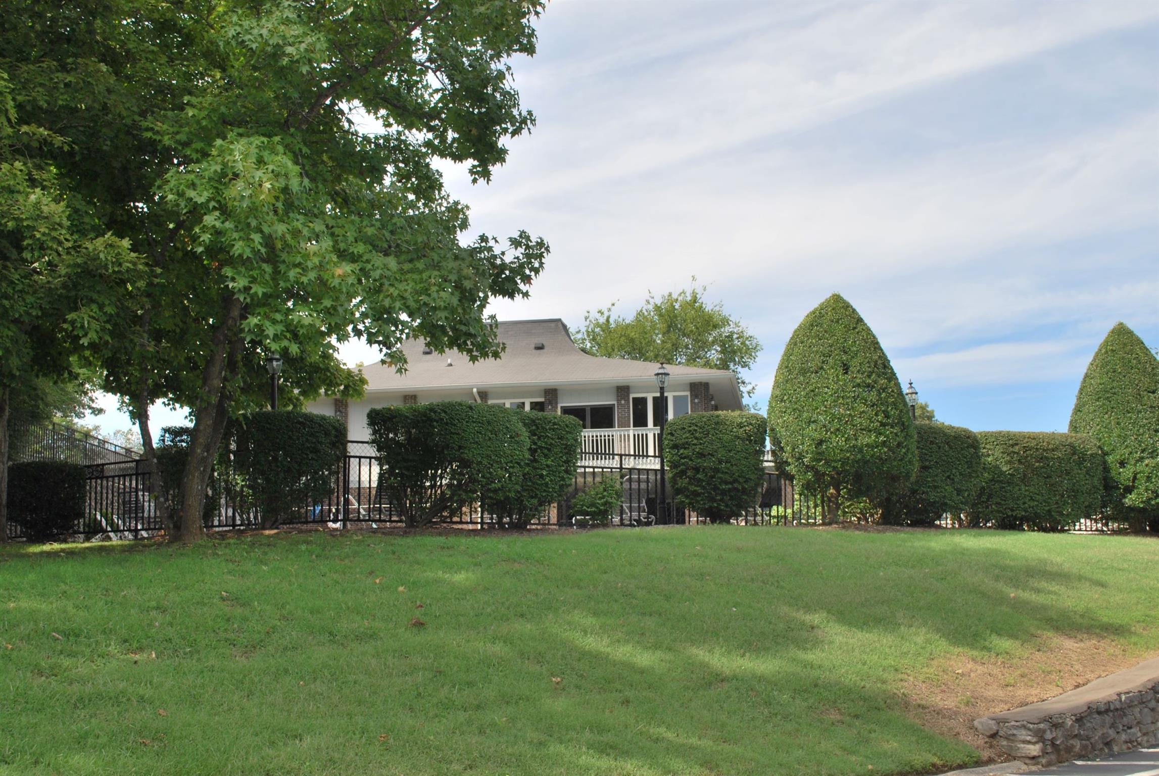 21 Vaughns Gap Road Nashville, TN 37205 - Photo 10 of 12 a view of a house with a big yard and potted plants and large trees