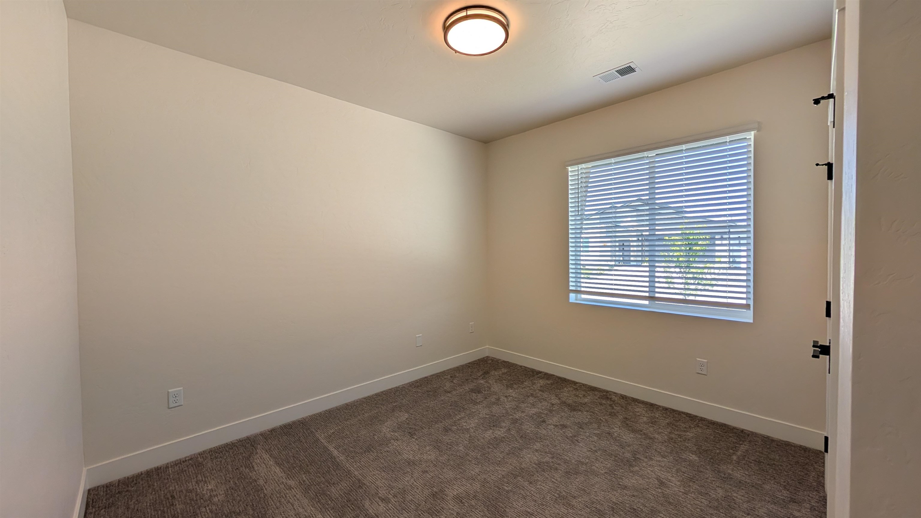 1660 Rusty Rivet Road Fruita, CO 81521 - Photo 6 of 15 an empty room with a window