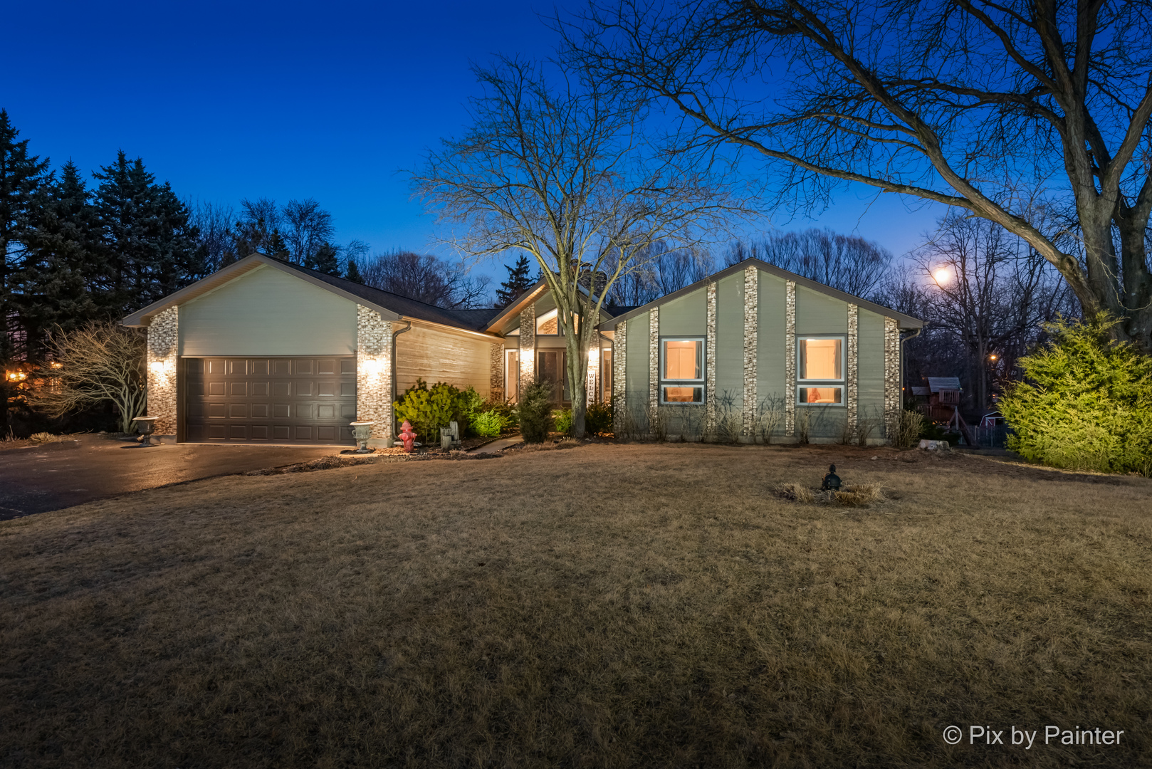 3134 Chellington Drive Johnsburg, IL 60051 - Photo 2 of 41 a front view of a house with a yard and garage