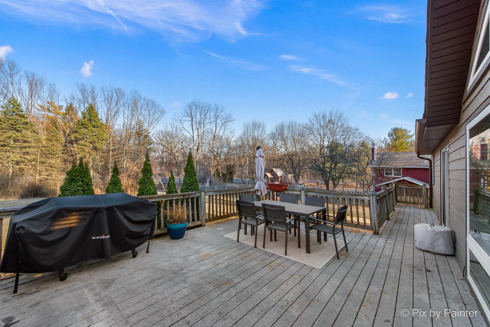 3134 Chellington Drive Johnsburg, IL 60051 - Photo 7 of 41 a view of a roof deck with table and chairs a barbeque with wooden floor and fence