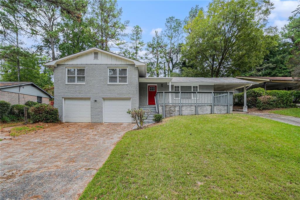 4031 Bakers Ferry Road Southwest Atlanta, GA 30331 - Photo 1 of 1 a front view of a house with a garden and yard