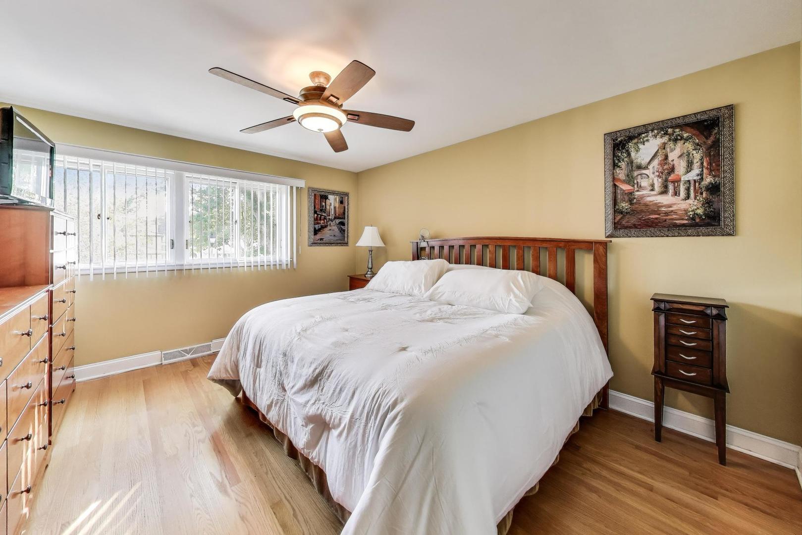 804 Euclid Avenue Elmhurst, IL 60126 - Photo 14 of 28 a bedroom with a large bed and a chandelier