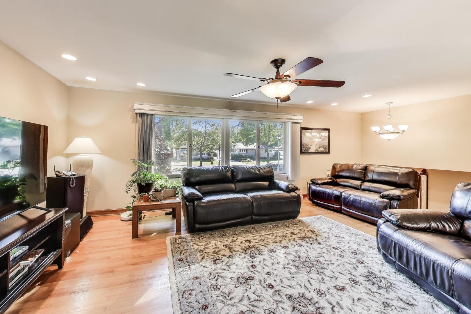 804 Euclid Avenue Elmhurst, IL 60126 - Photo 3 of 28 a living room with furniture a flat screen tv and a large window