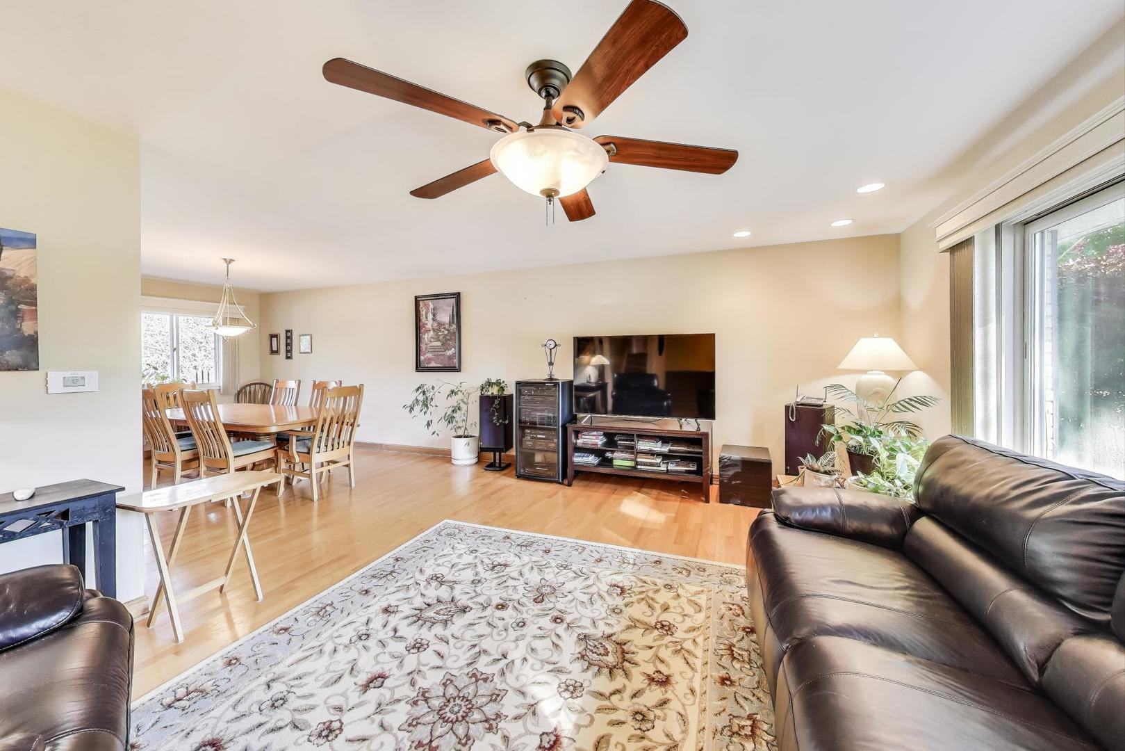 804 Euclid Avenue Elmhurst, IL 60126 - Photo 4 of 28 a living room with furniture a fireplace and a flat screen tv