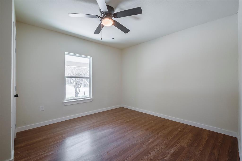 1101 Anthony Street McKinney, TX 75069 - Photo 13 of 26 an empty room with wooden floor ceiling fan and windows