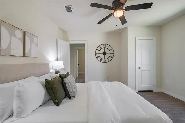 a bedroom with a bed and painting on the wall