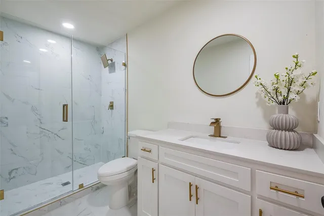 a bathroom with a sink a toilet and a mirror