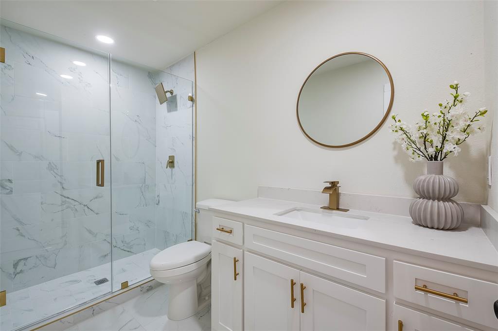 1101 Anthony Street McKinney, TX 75069 - Photo 19 of 26 a bathroom with a sink a toilet and a mirror