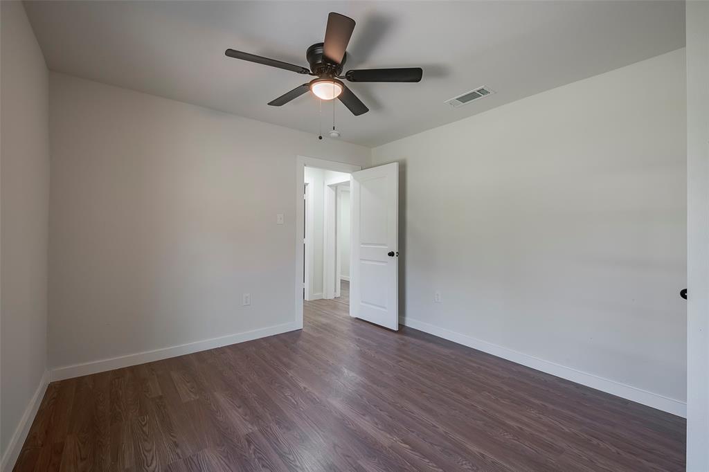 1101 Anthony Street McKinney, TX 75069 - Photo 22 of 26 a view of a room with wooden floor and ceiling fan
