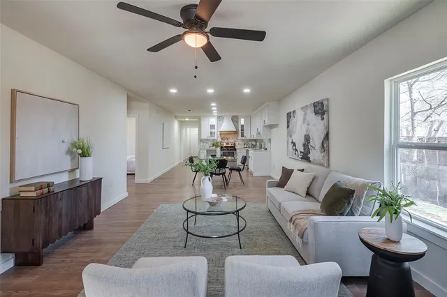 a living room with furniture potted plant and a chandelier