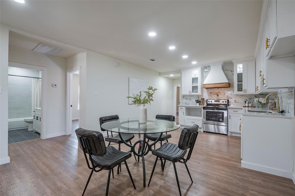 1101 Anthony Street McKinney, TX 75069 - Photo 7 of 26 a view of a dining room with furniture and wooden floor