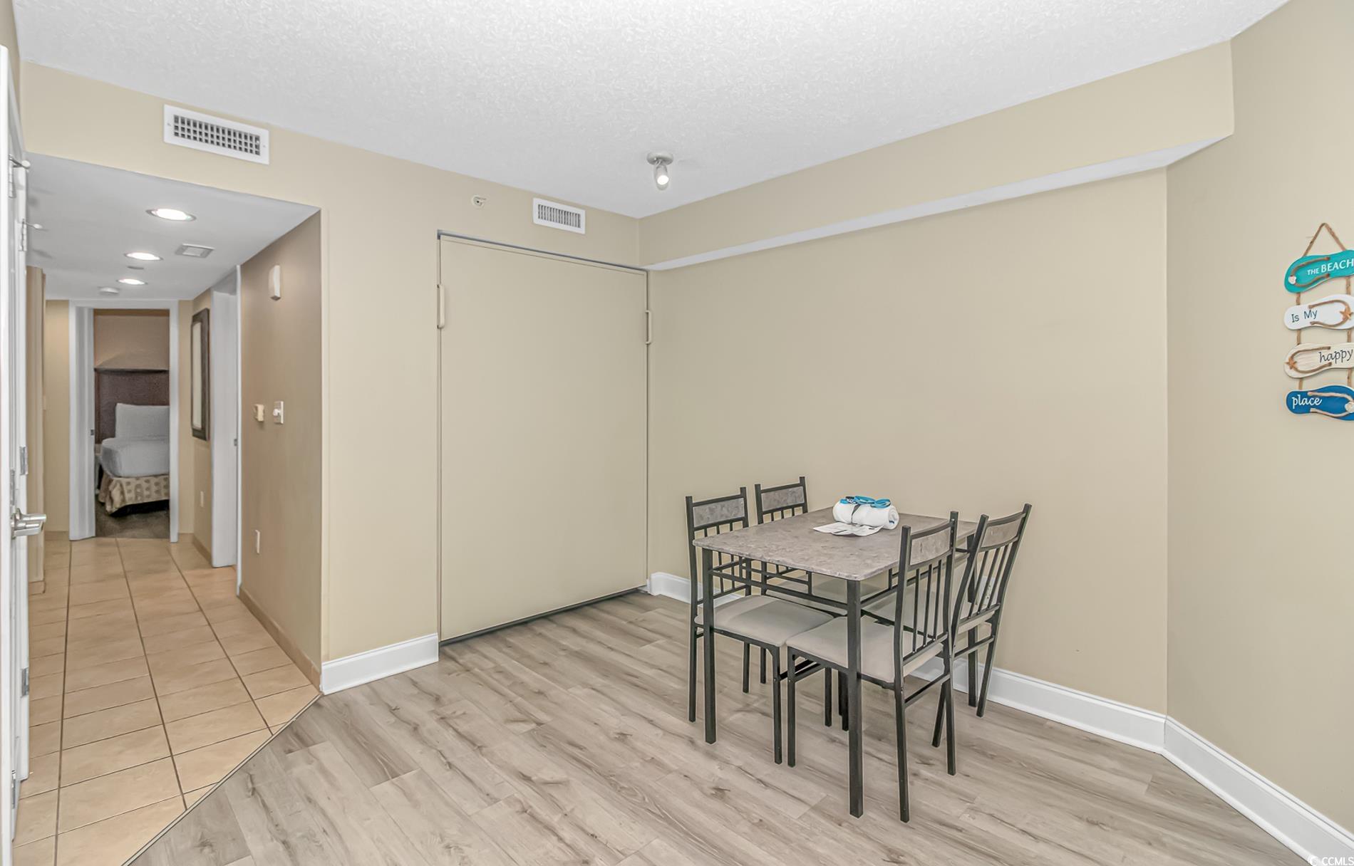 201 South Ocean Boulevard, Unit 1905 Myrtle Beach, SC 29577 - Photo 12 of 32 Dining area featuring light wood-style flooring, a textured ceiling, and recessed lighting