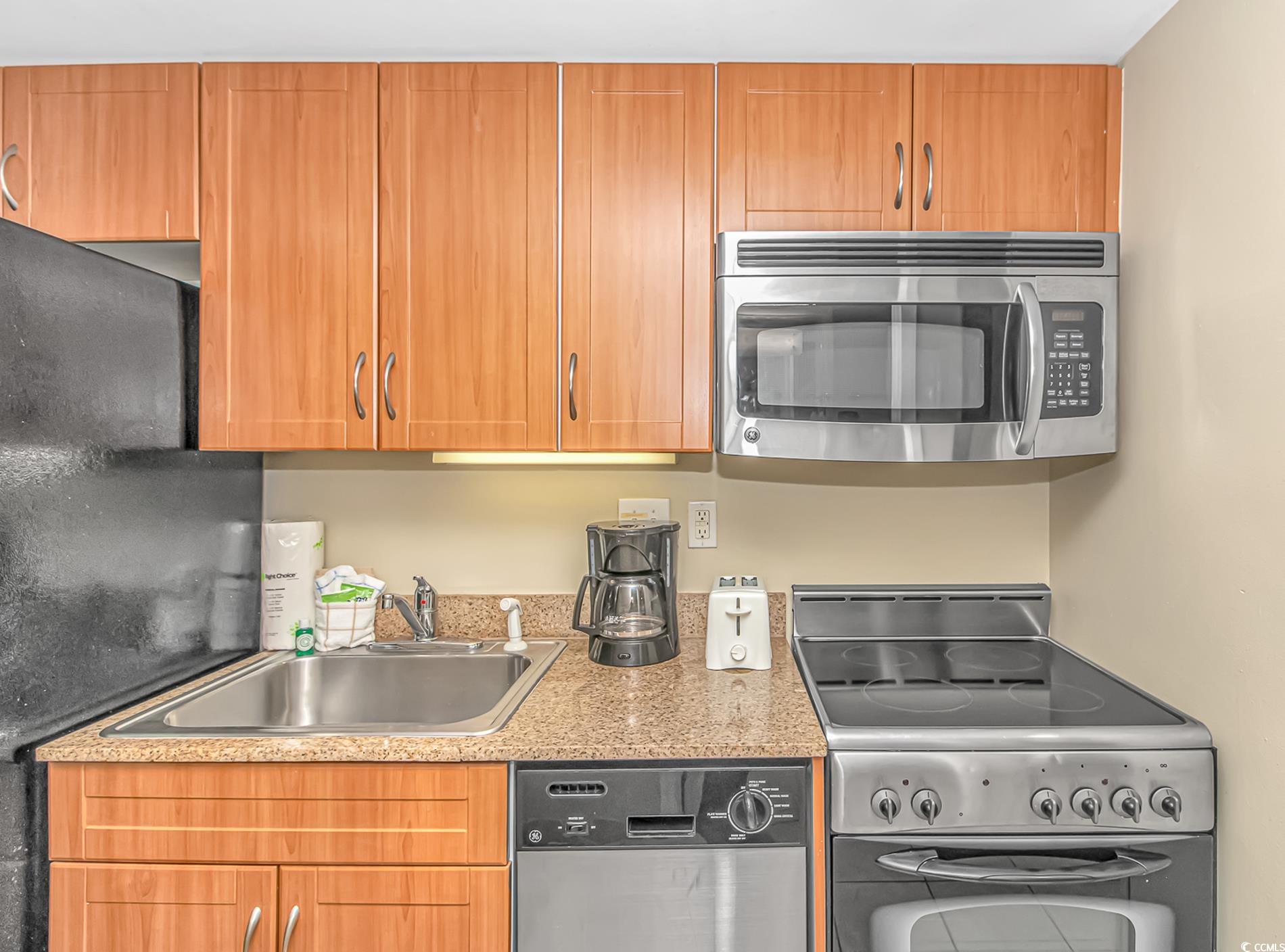 201 South Ocean Boulevard, Unit 1905 Myrtle Beach, SC 29577 - Photo 13 of 32 Kitchen featuring stainless steel appliances and brown cabinets