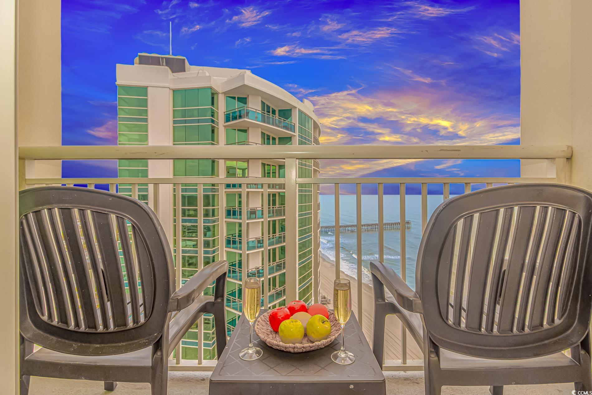 201 South Ocean Boulevard, Unit 1905 Myrtle Beach, SC 29577 - Photo 2 of 32 Balcony at dusk featuring a water view
