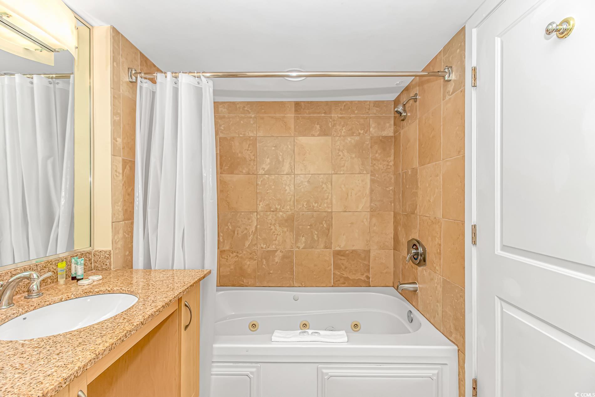 201 South Ocean Boulevard, Unit 1905 Myrtle Beach, SC 29577 - Photo 21 of 32 Bathroom featuring a combined bath / shower with jetted tub and vanity