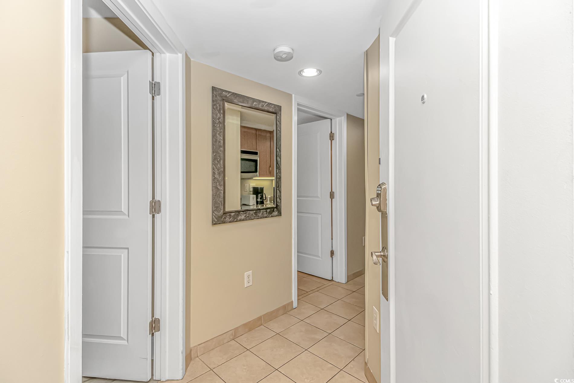 201 South Ocean Boulevard, Unit 1905 Myrtle Beach, SC 29577 - Photo 23 of 32 Hallway with light tile patterned floors and baseboards
