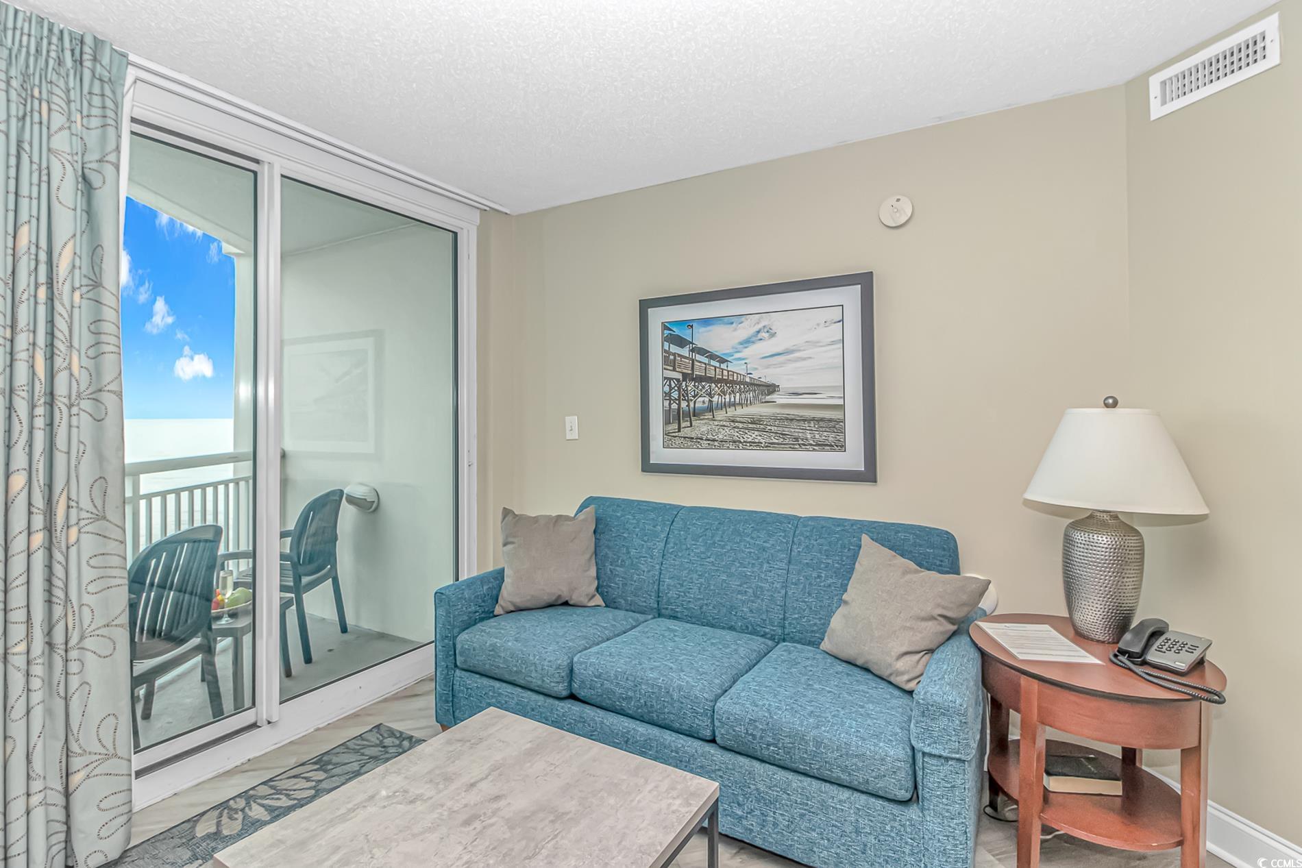 201 South Ocean Boulevard, Unit 1905 Myrtle Beach, SC 29577 - Photo 6 of 32 Living room featuring a textured ceiling and wood finished floors