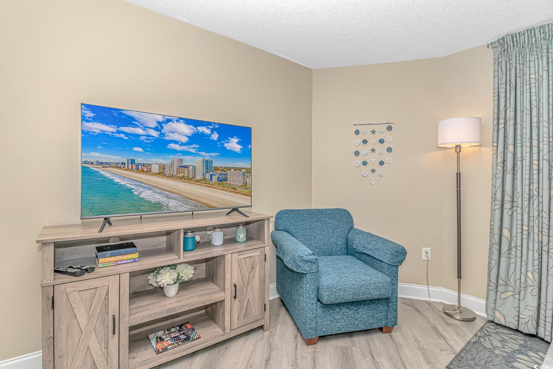 201 South Ocean Boulevard, Unit 1905 Myrtle Beach, SC 29577 - Photo 8 of 32 Sitting room featuring light wood-type flooring and a textured ceiling