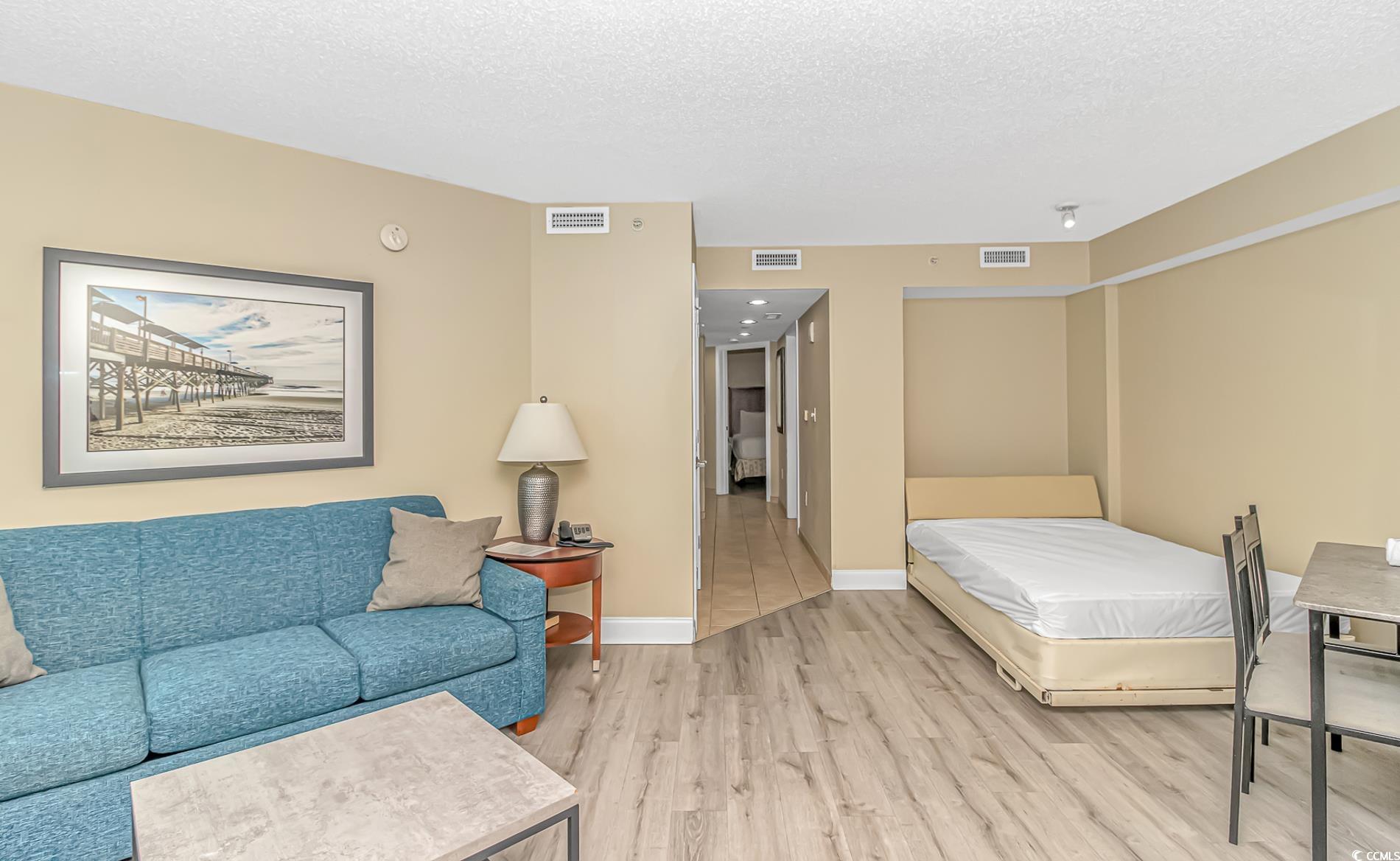 201 South Ocean Boulevard, Unit 1905 Myrtle Beach, SC 29577 - Photo 9 of 32 Bedroom featuring a textured ceiling and wood finished floors