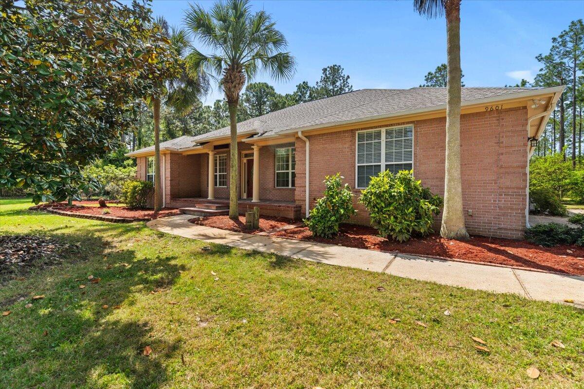 a view of a house with swimming pool and sitting area