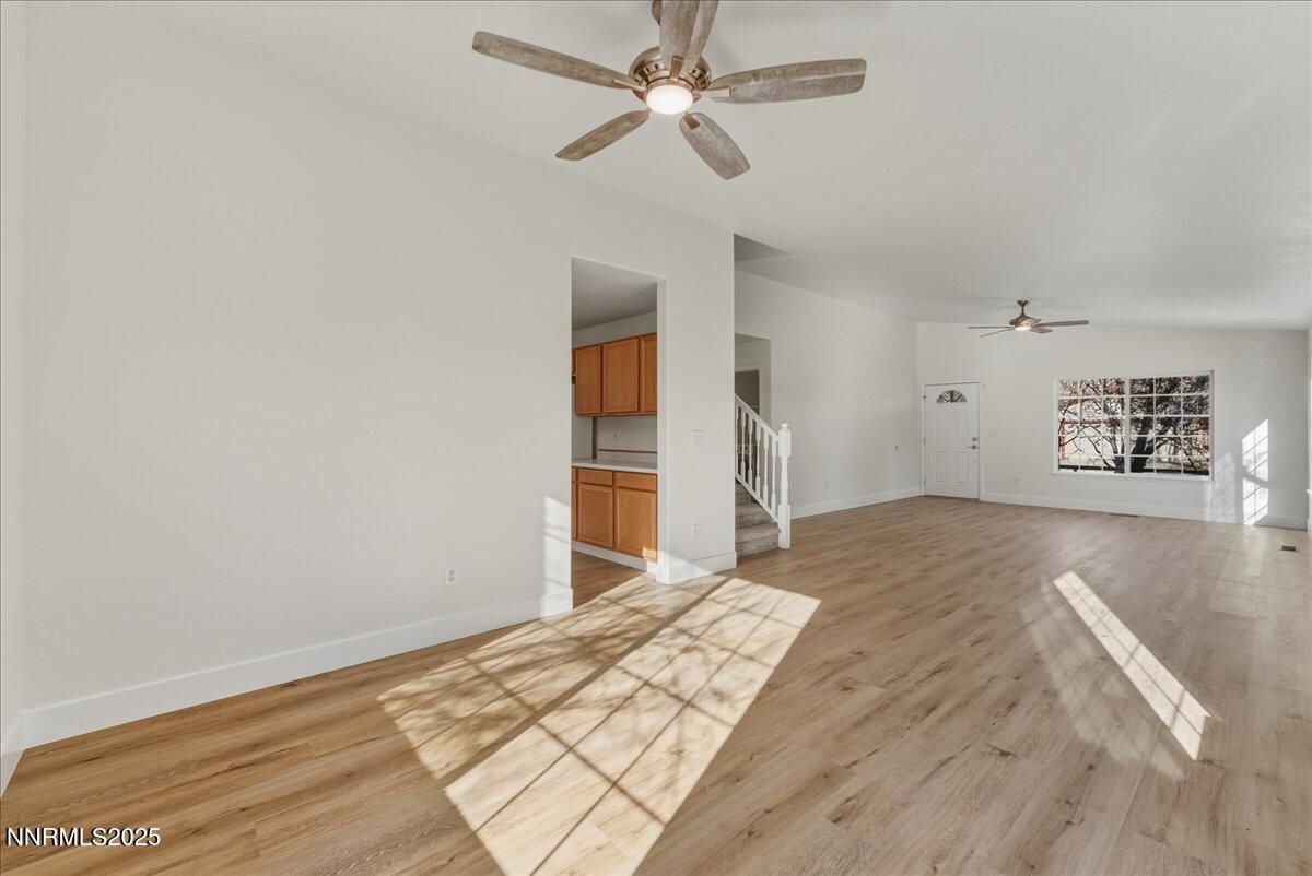 17598 Elk Court Reno, NV 89508 - Photo 11 of 43 a view of empty room with wooden floor and ceiling fan