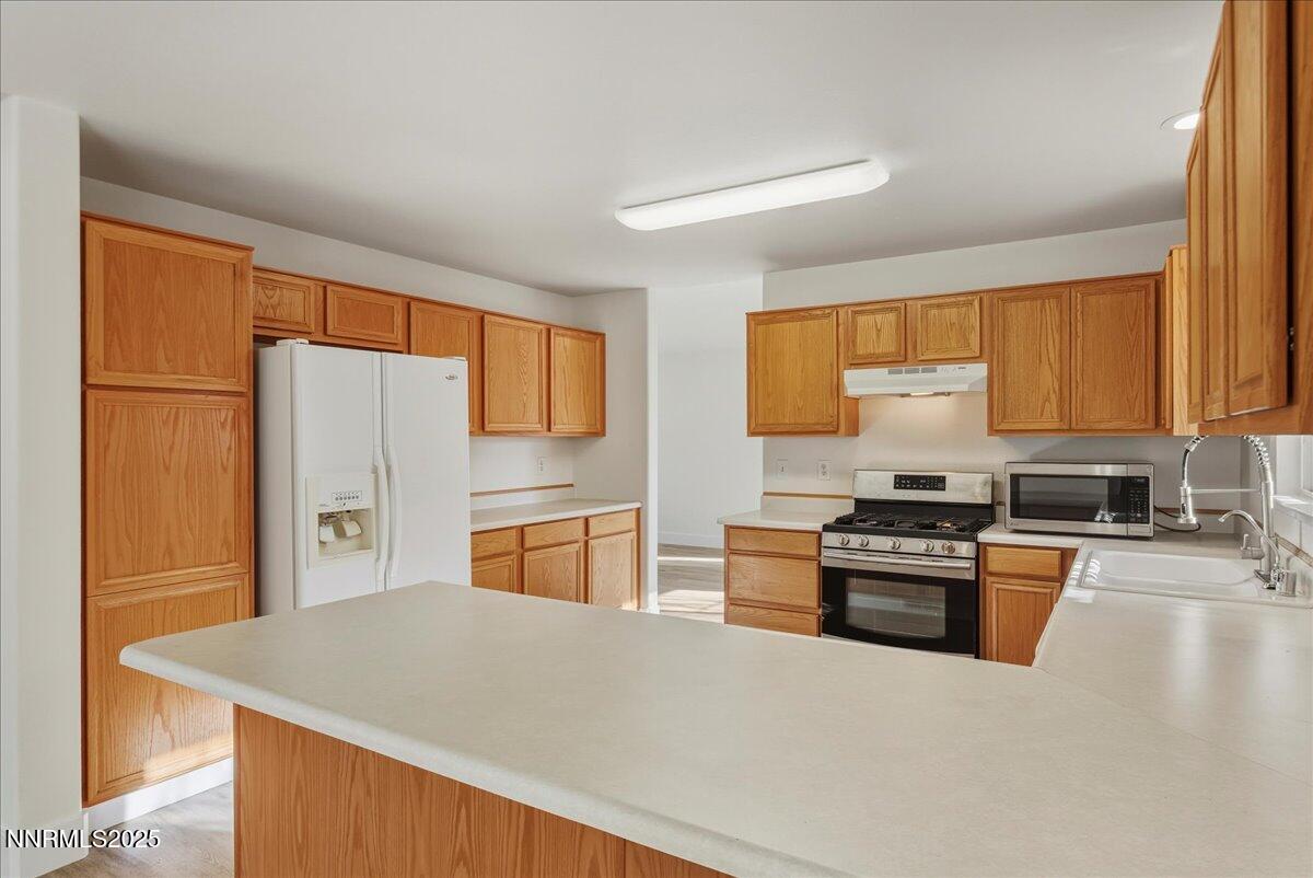 17598 Elk Court Reno, NV 89508 - Photo 14 of 43 a kitchen with stainless steel appliances granite countertop a stove refrigerator sink and dishwasher