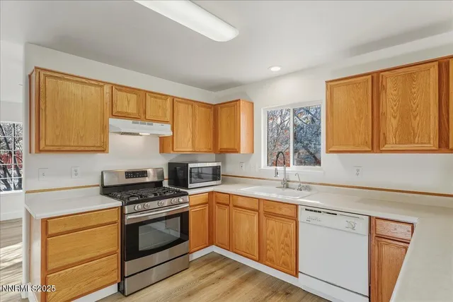 a kitchen with stainless steel appliances a stove sink and cabinets