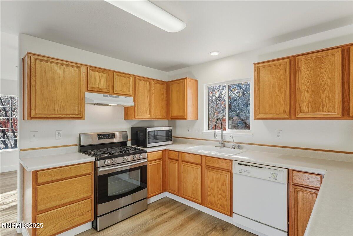 17598 Elk Court Reno, NV 89508 - Photo 15 of 43 a kitchen with stainless steel appliances a stove sink and cabinets