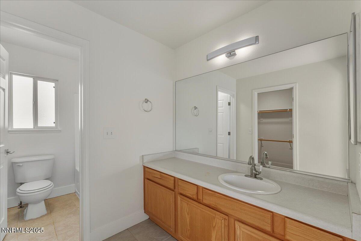 17598 Elk Court Reno, NV 89508 - Photo 24 of 43 a bathroom with a granite countertop sink toilet and mirror