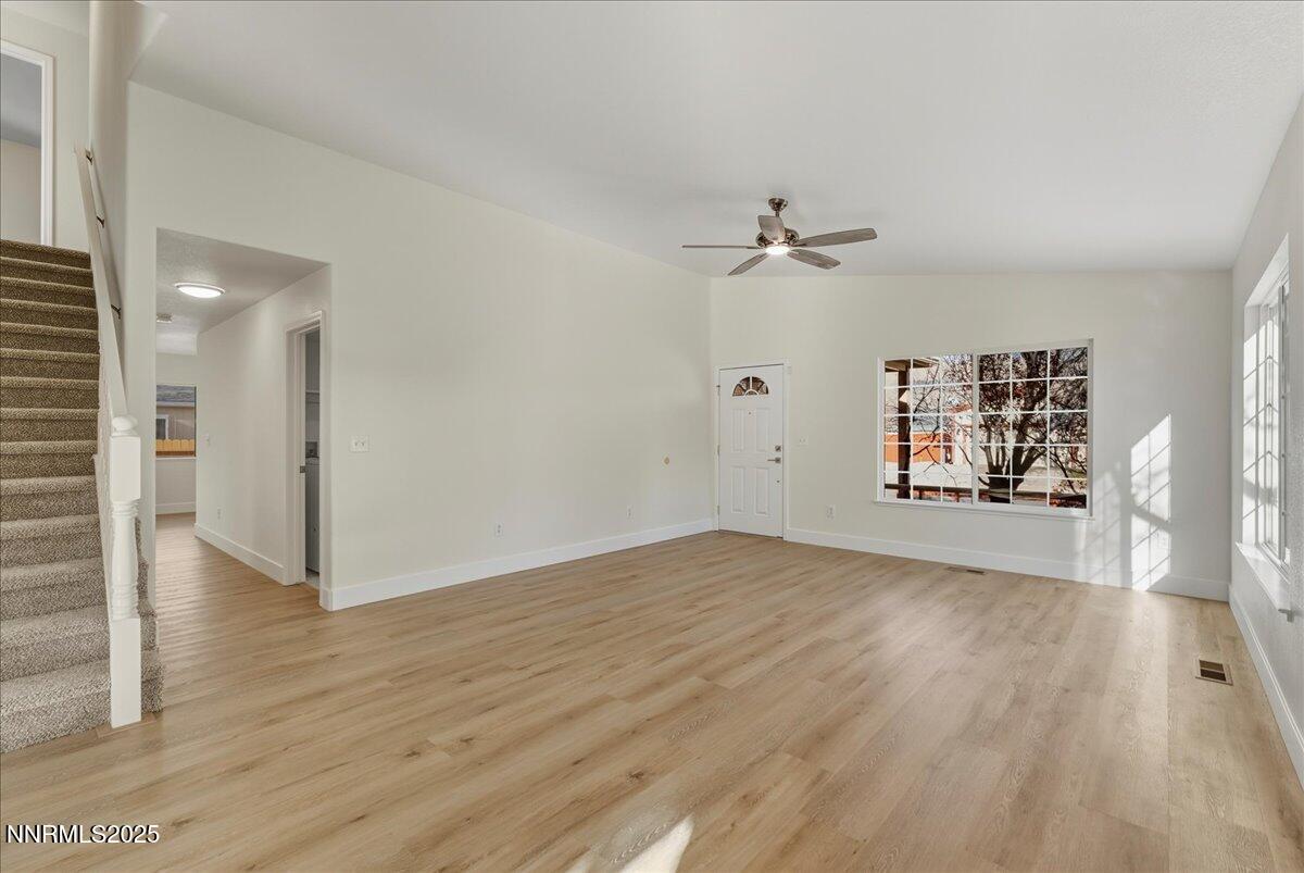 17598 Elk Court Reno, NV 89508 - Photo 8 of 43 an empty space with wooden floor and a ceiling fan