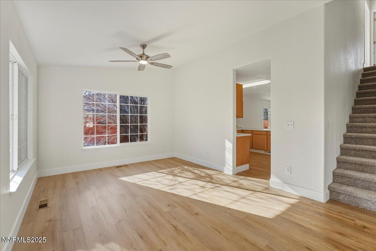 17598 Elk Court Reno, NV 89508 - Photo 10 of 43 an empty room with wooden floor ceiling fan and windows