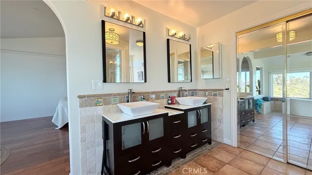 a bedroom with furniture and wooden floor