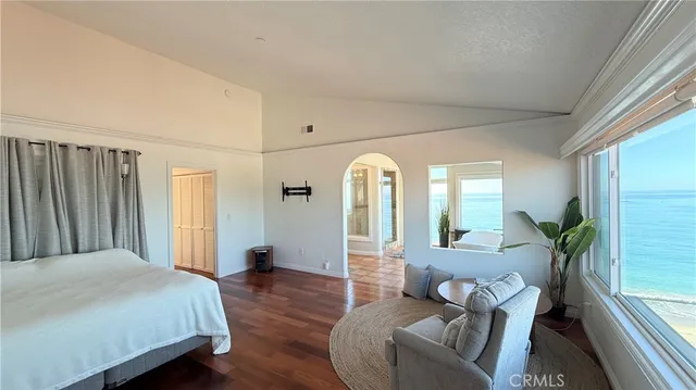 a hallway with wooden floor and windows