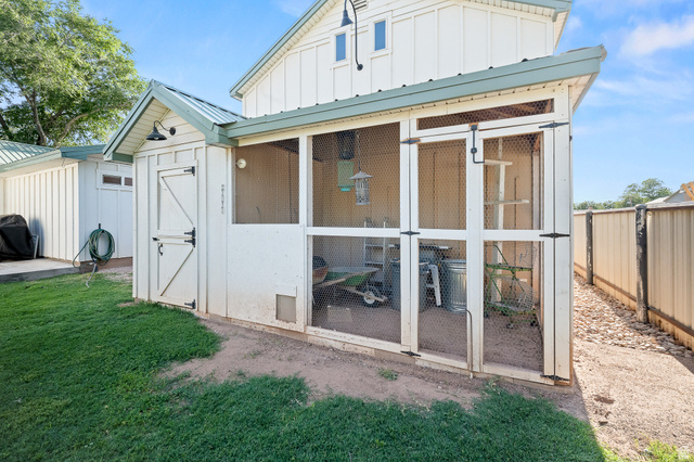 236 West 300 South Hurricane, UT 84737 - Photo 63 of 76 Dedicated animal enclosure featuring a white board and batten siding, a screened-in area, and a metal roof
